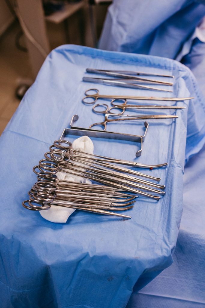 A table topped with lots of surgical tools